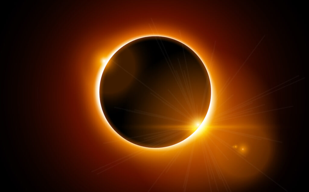 The moon totally covering the sun during a solar eclipse. The moon and sky surrounding are pitch black.